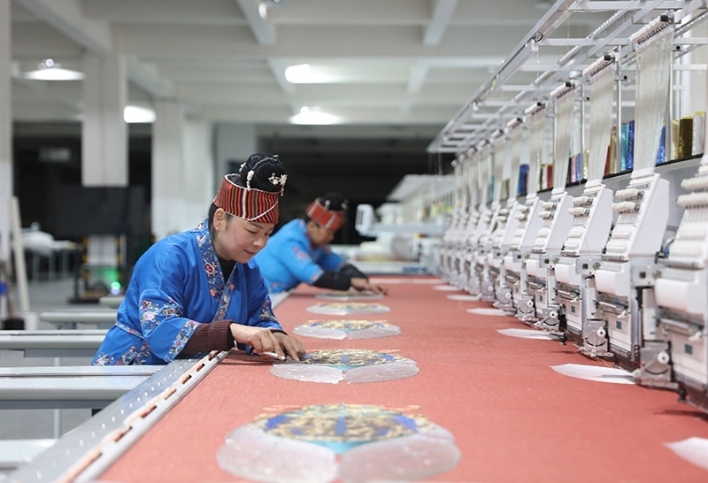 2023年2月13日，貴州省黔東南苗族侗族自治州施秉縣工業(yè)園區(qū)，工人在機(jī)繡車間作業(yè)。