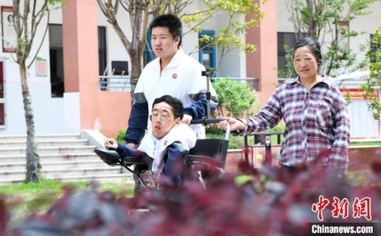 碰上天氣好，朱金祥就會利用休息時間，和鐘華強母親將其推出來賞賞花，曬曬太陽，呼吸一下外面的新鮮空氣。 卓忠偉 攝