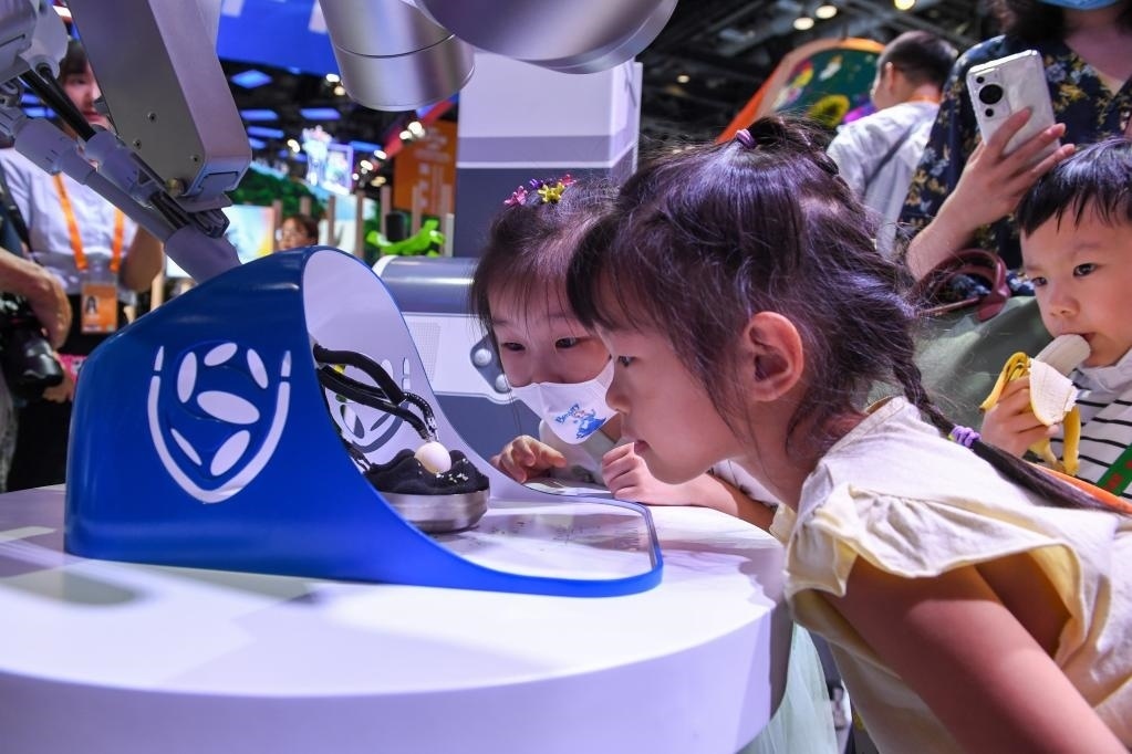 9月3日，幾名小朋友在國家會議中心觀看單孔腔鏡手術機器人展示。新華社記者 鞠煥宗 攝