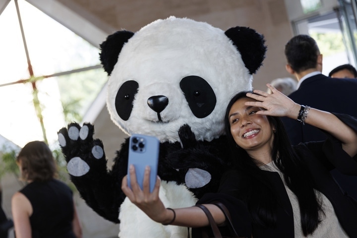 2022年8月24日，在美國華盛頓中國駐美國大使館，來賓與大熊貓玩偶合影。