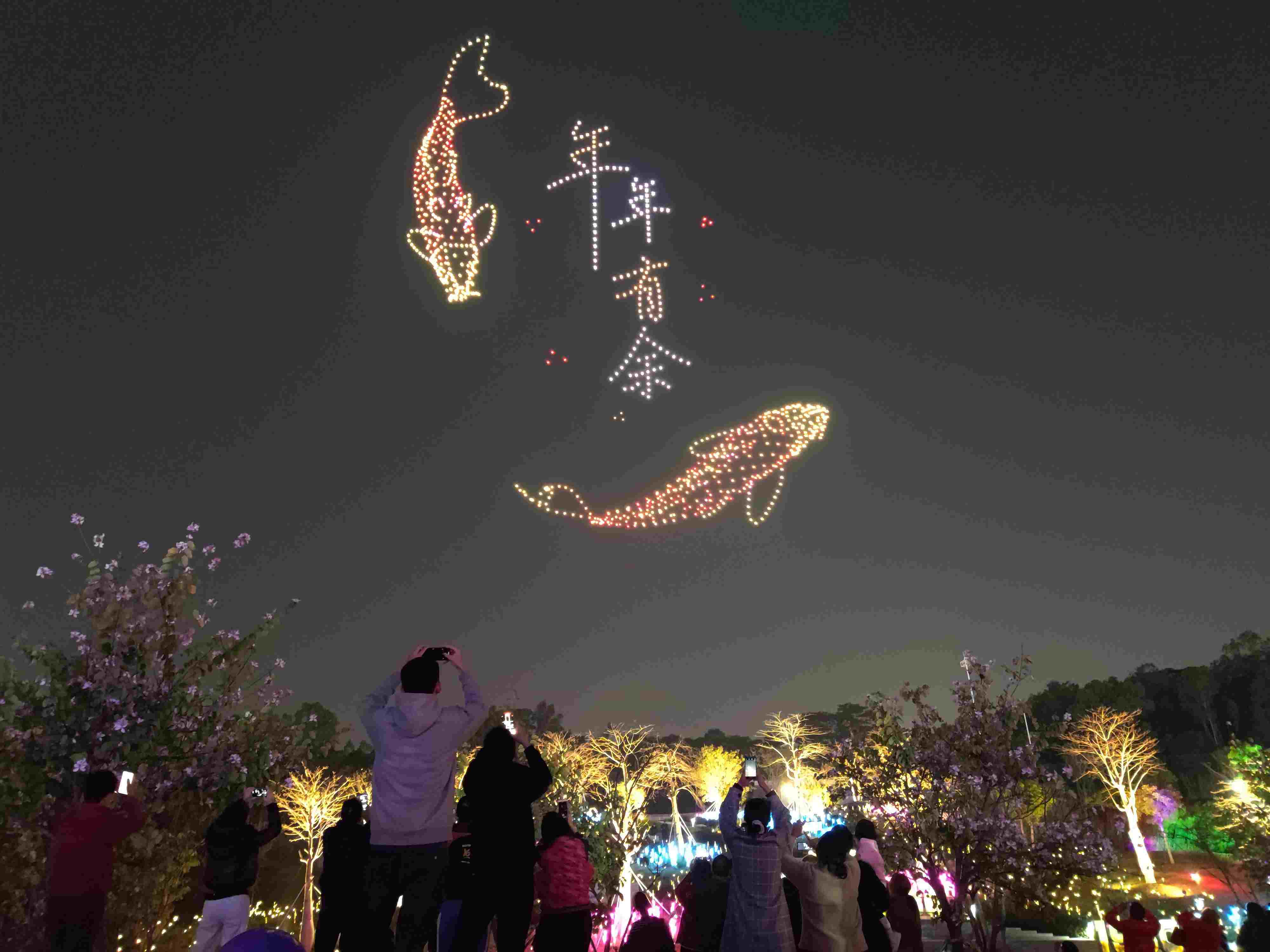 △ 2024年2月10日，深圳北站中心公園，春節(jié)主題無人機(jī)燈光秀引來眾多游客駐足觀看。