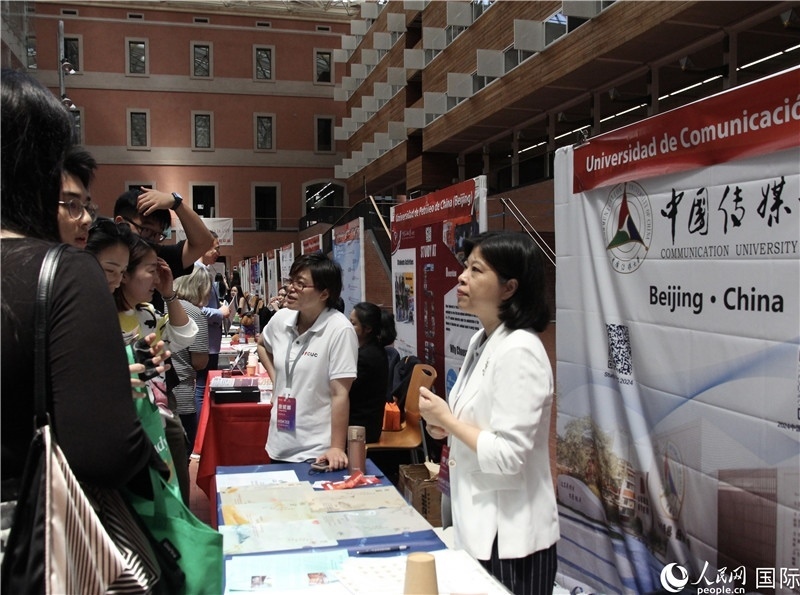 旅西華人華僑在展臺(tái)前咨詢。人民網(wǎng)記者 許海林?jǐn)z