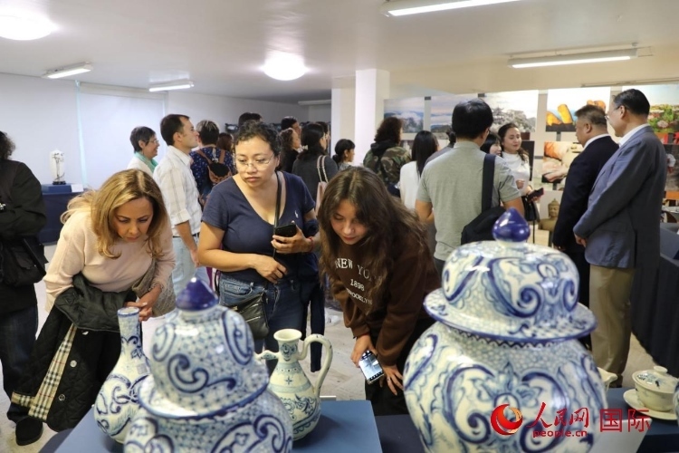 在展覽現(xiàn)場(chǎng)，觀眾們駐足欣賞德化瓷和墨西哥彩瓷。人民網(wǎng) 埃內(nèi)斯托·多明戈斯攝