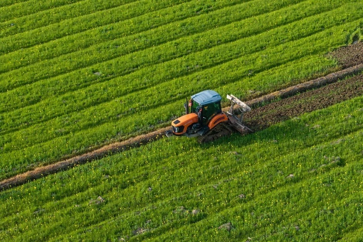 2024年3月19日，在湖南省常德市鼎城區(qū)謝家鋪鎮(zhèn)港中坪村，村民駕駛農(nóng)機(jī)翻耕田地（無人機(jī)照片）。新華社記者 陳思汗 攝