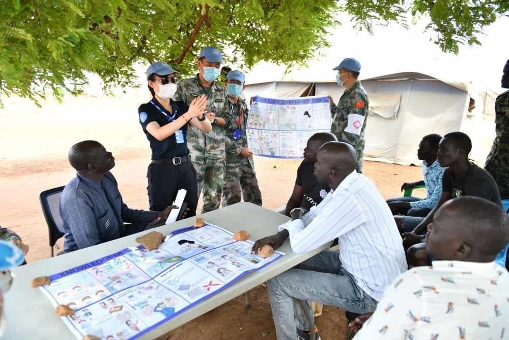 2020年3月，在南蘇丹首都朱巴，執(zhí)行聯(lián)合國維和任務(wù)的中國維和警察廖潔給當(dāng)?shù)鼐熘v解防疫知識。