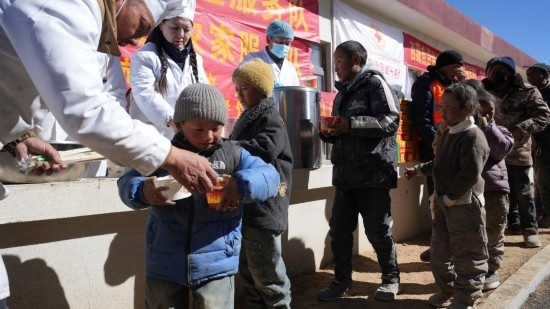 1月14日，廚師們正在給前來用餐的小朋友們打飯。新華社記者 邱星翔 攝