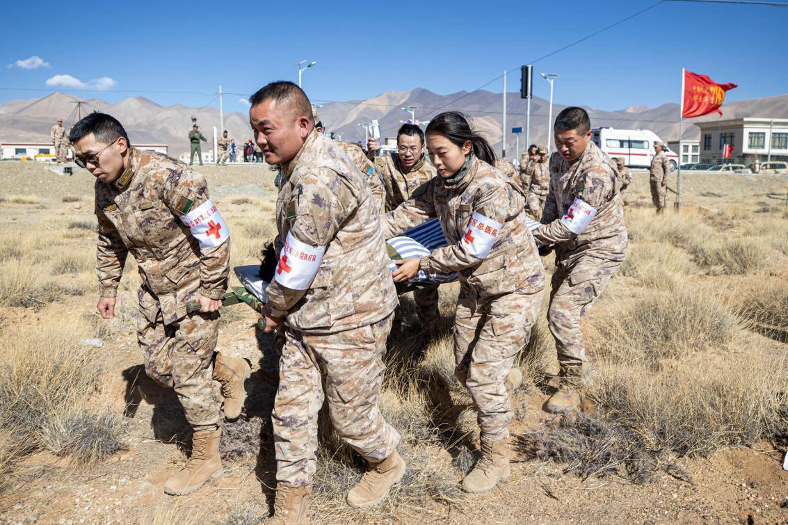 1月9日，日喀則定日縣長所鄉(xiāng)，西藏軍區(qū)總醫(yī)院醫(yī)療隊(duì)隊(duì)員將受傷村民用擔(dān)架從救護(hù)車準(zhǔn)備抬上直升機(jī)，轉(zhuǎn)運(yùn)至拉薩的西藏軍區(qū)總醫(yī)院救治。人民日報(bào)記者張武軍攝